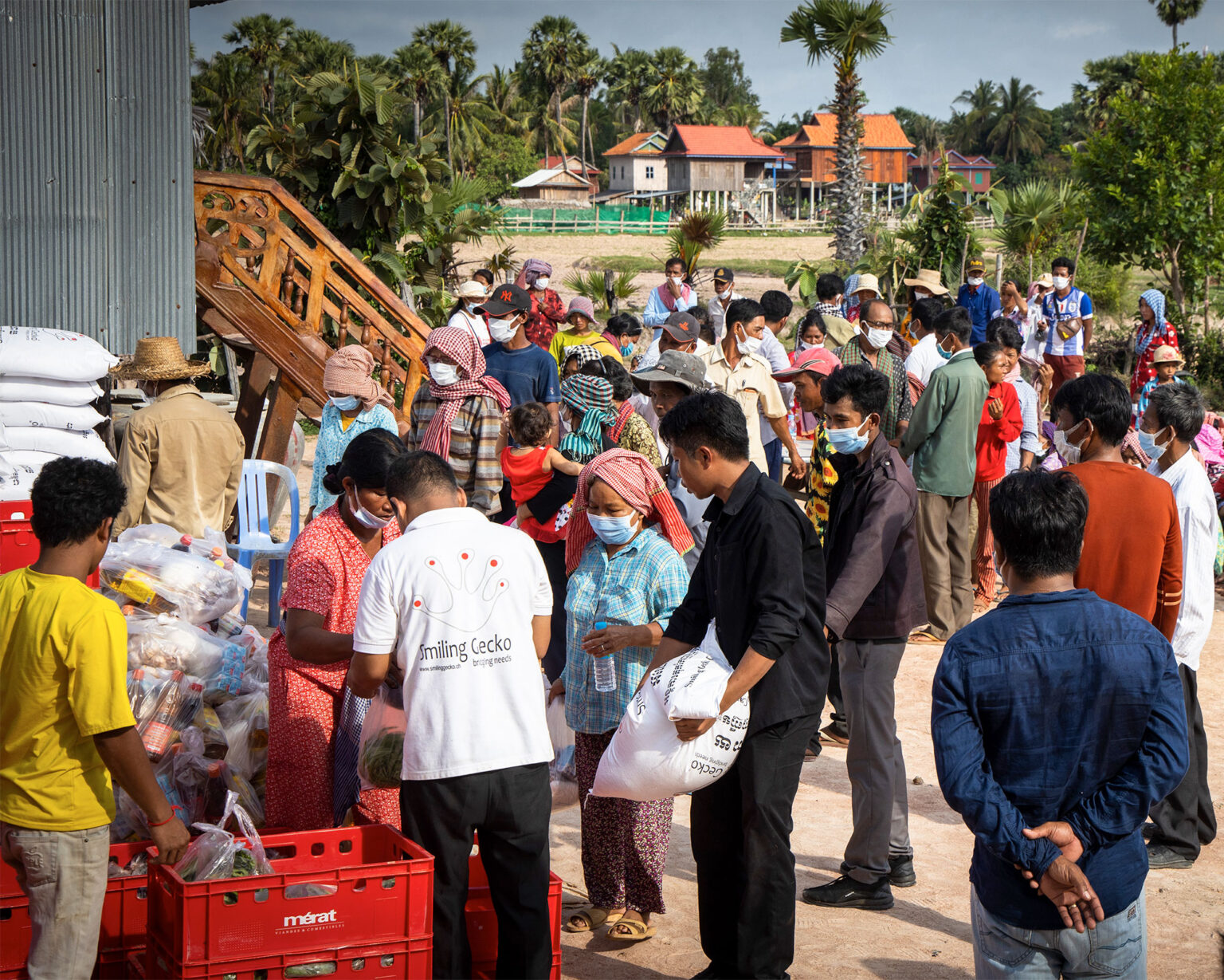 Distribution of relief supplies to a gathered group.