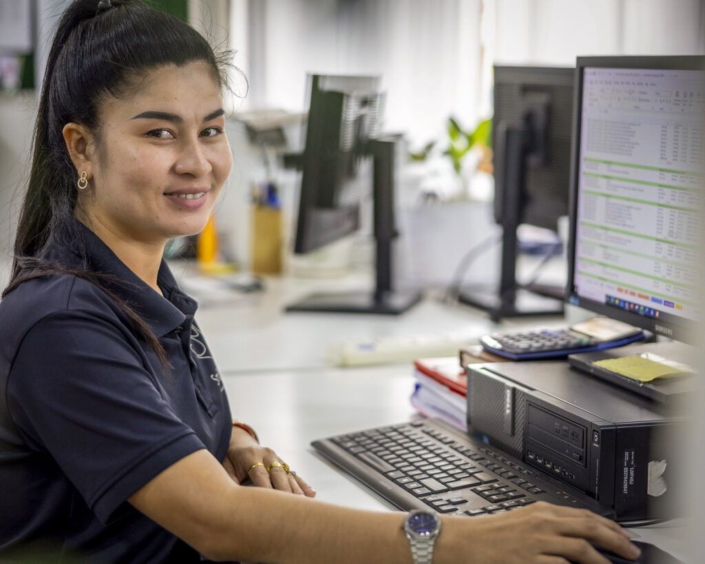 Staff member working at a computer in the office.