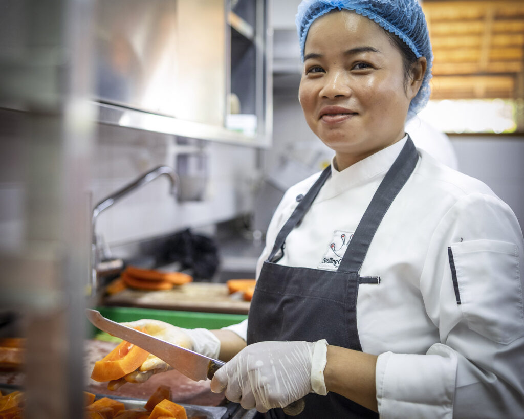 Chef preparing vegetables in the large kitchen.