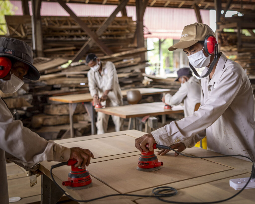 Trainees working with wood in the carpentry workshop.