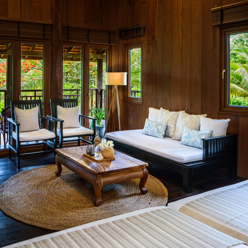 Living area with a sofa in a wooden bungalow.