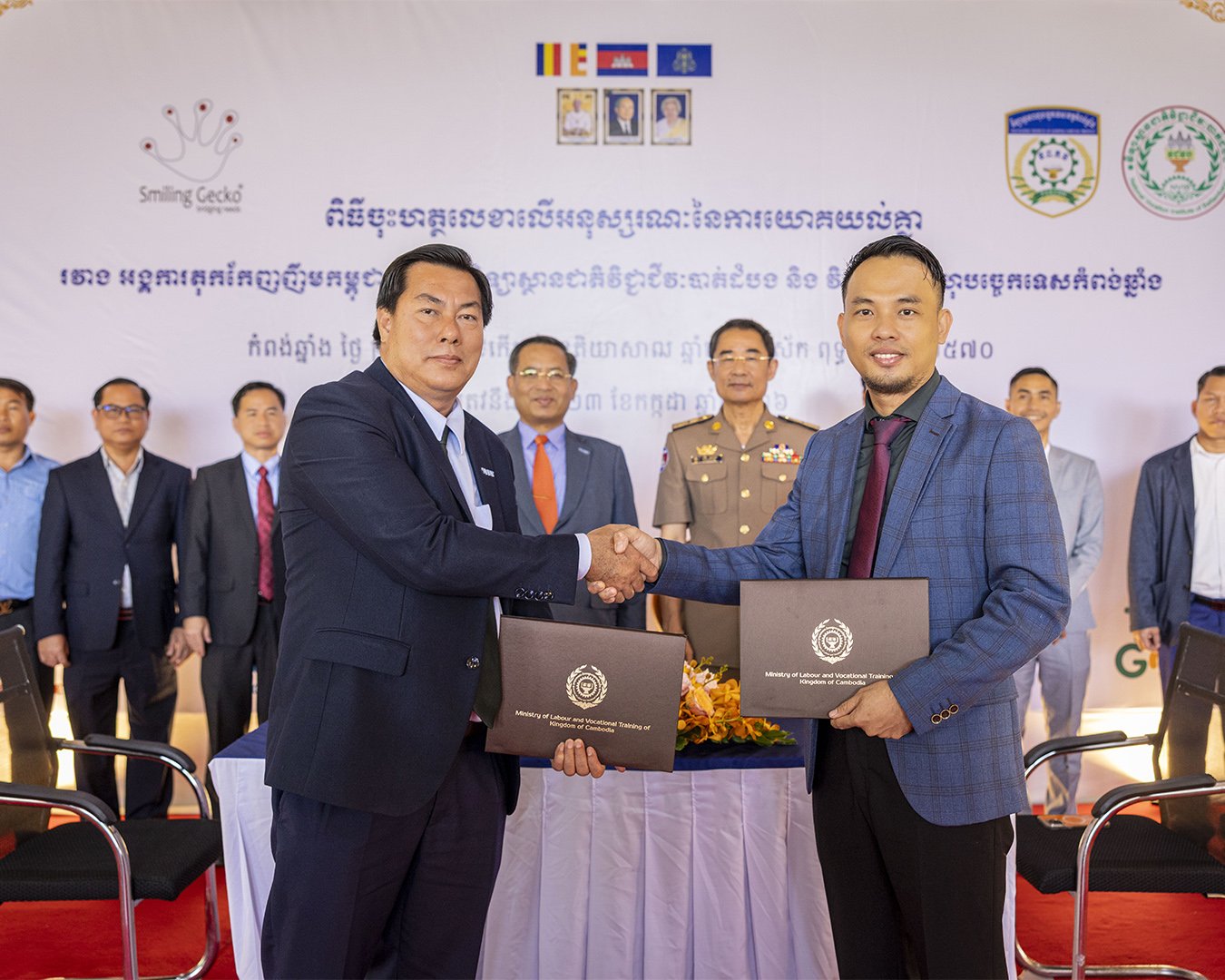 Ceremonial presentation of a document related to vocational training.
